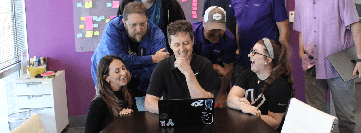 The Next 20 Years - David's Final Thoughts on 20 Moments/20 Years - David and team laughing around a computer screen
